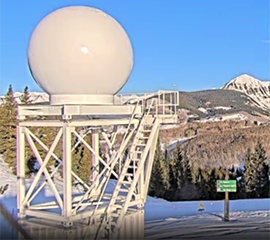 Snow blankets the ground in front of the Colorado State University X-band radar.